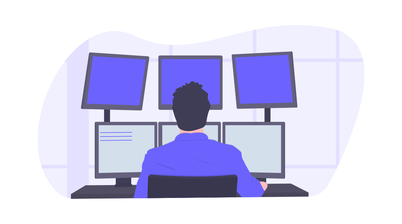 A man looking at 3 monitors, working